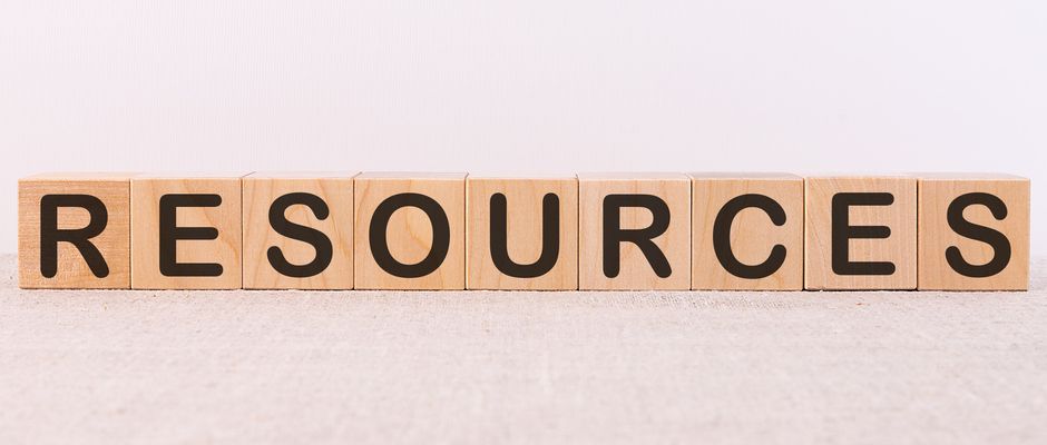 RESOURCES word concept written on wooden cubes lying on a light table and light background.