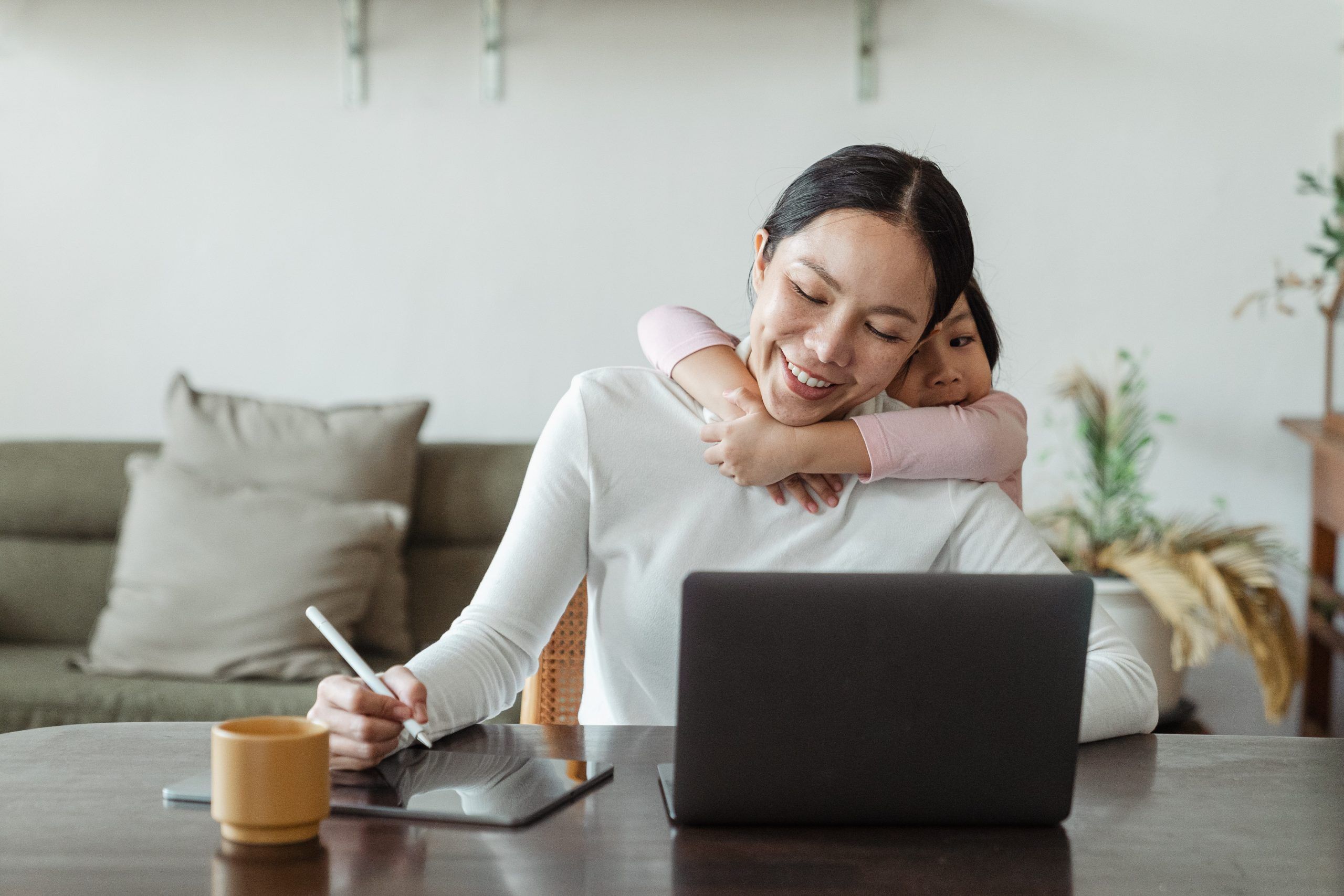 Woman with child working on a laptop