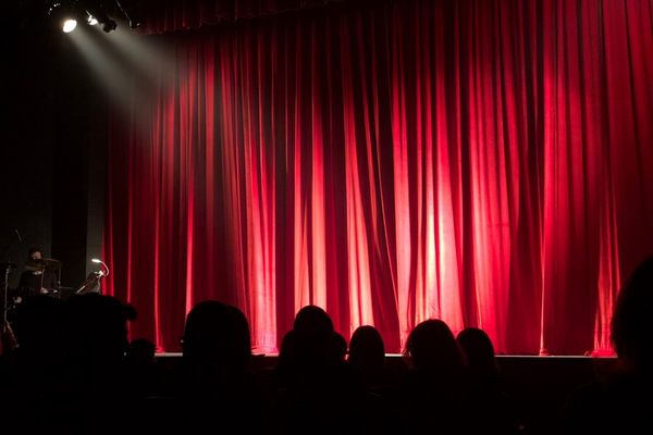 Red curtain with spotlight on stage
