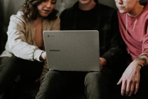 Photo of students working together on a laptop